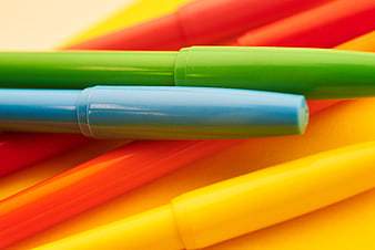 Close-up of colorful highlighters and markers on paper