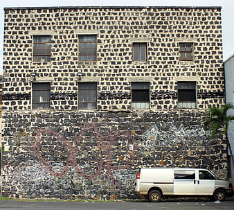 White Van Parked Against Old Stone Building Facade