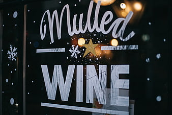 Mulled Wine Sign on Glass Window with Christmas Decorations