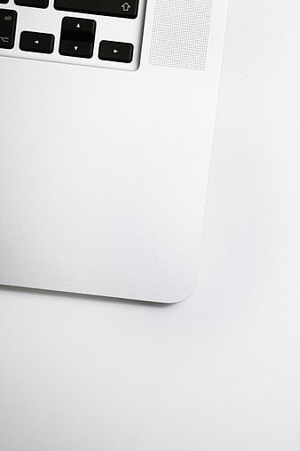 Minimalist White Laptop Corner with Keyboard and Copyspace