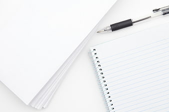 Minimalist white notebook and pen on clean background