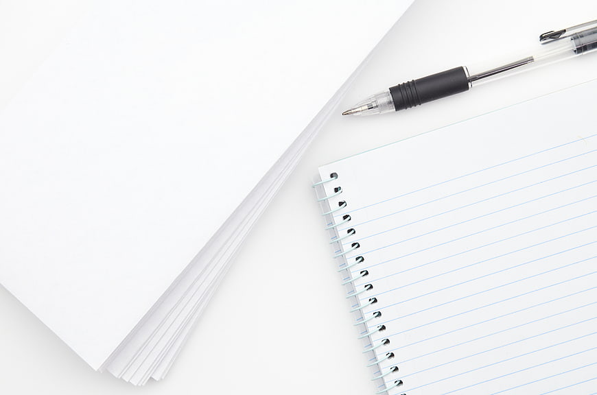 Minimalist white notebook and pen on clean background