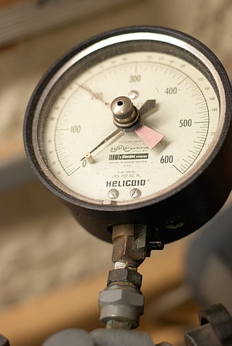 Close-up of vintage industrial pressure gauge with needle
