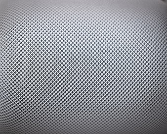 Close-up of white perforated mesh texture background