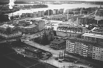 Aerial tilt-shift view of city with church and river