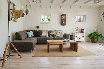 Bright rustic living room with white brick walls and wooden furniture