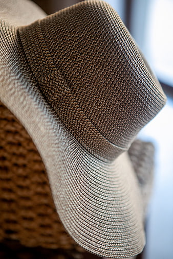 Close-up of beige woven straw hat texture