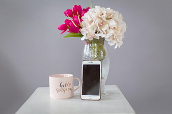 Pink Mug, Smartphone, and Flowers on White Table