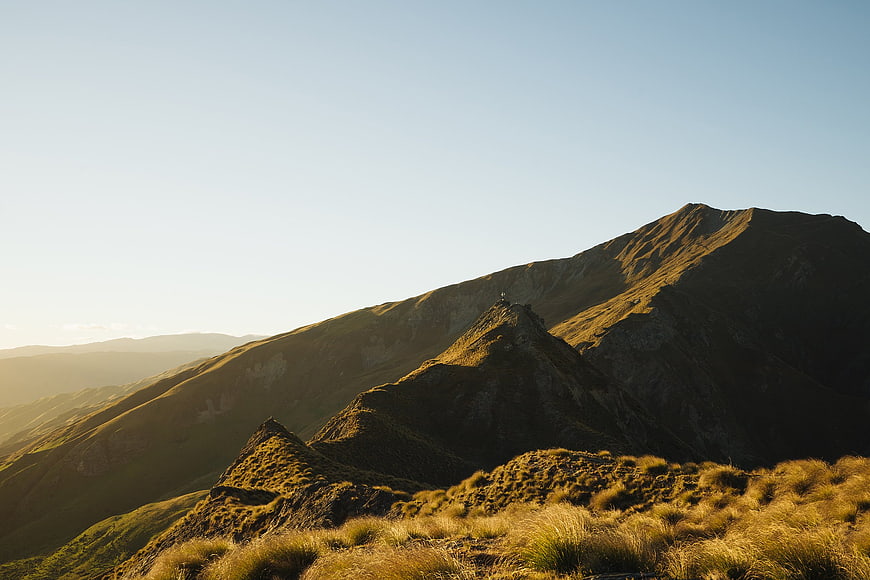 Golden Hour Mountain Ridge Landscape with Grassy Foreground