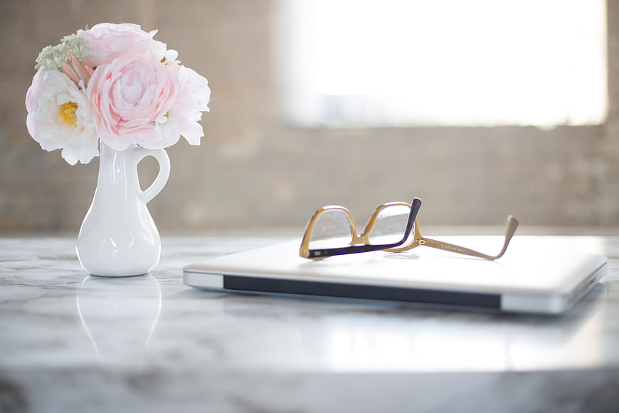 Pink Peonies in White Vase with Glasses on Laptop