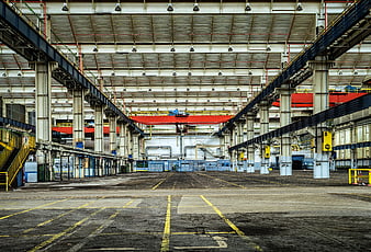Empty Industrial Warehouse Interior with Red Crane