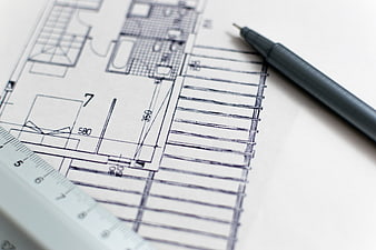 Architectural blueprint with pen and ruler on white background