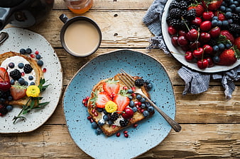 Overhead view of rustic breakfast toast with berries and coffee