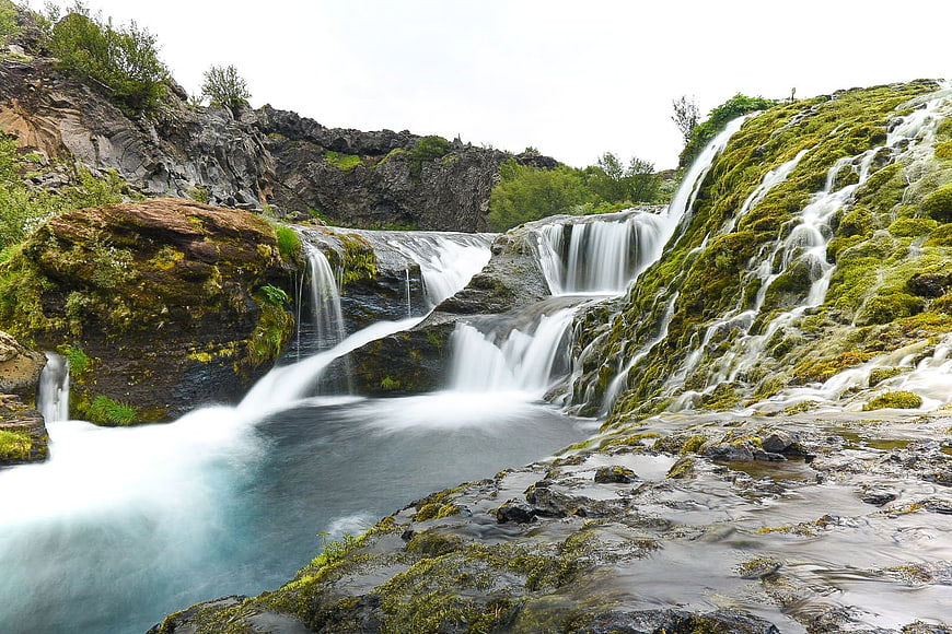 Mossy waterfall cascading over rocks in lush nature