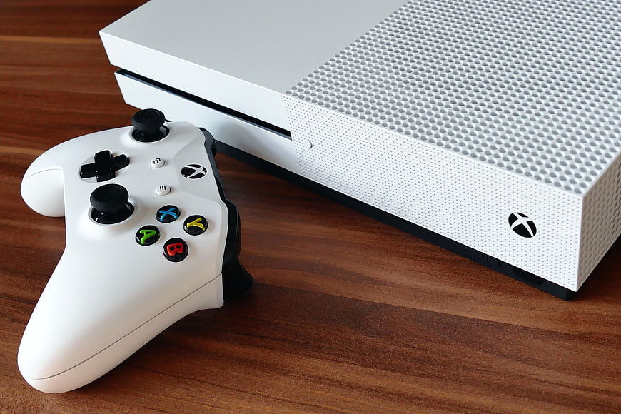 White Xbox One S Console and Controller on Wooden Table