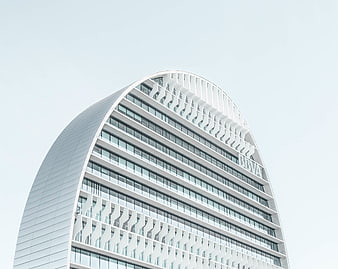 Modern curved white skyscraper with geometric facade