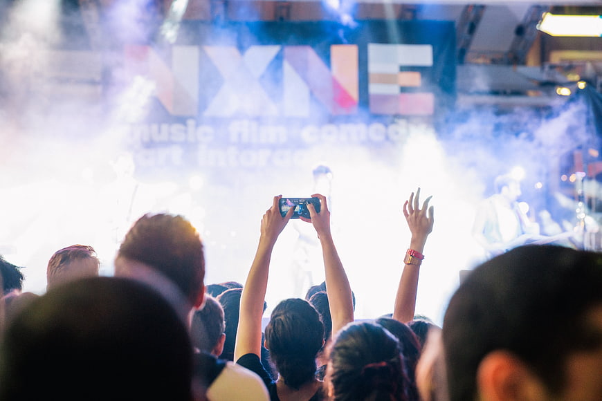 Audience recording live concert performance with smartphone