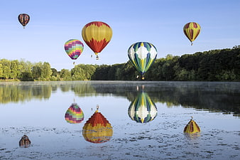 Colorful Hot Air Balloons Reflecting on Misty Lake
