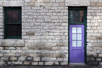 Purple Door on Old Stone Wall with Green Window