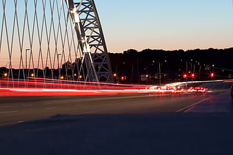 Long Exposure Traffic Light Trails on Modern Bridge at Dusk