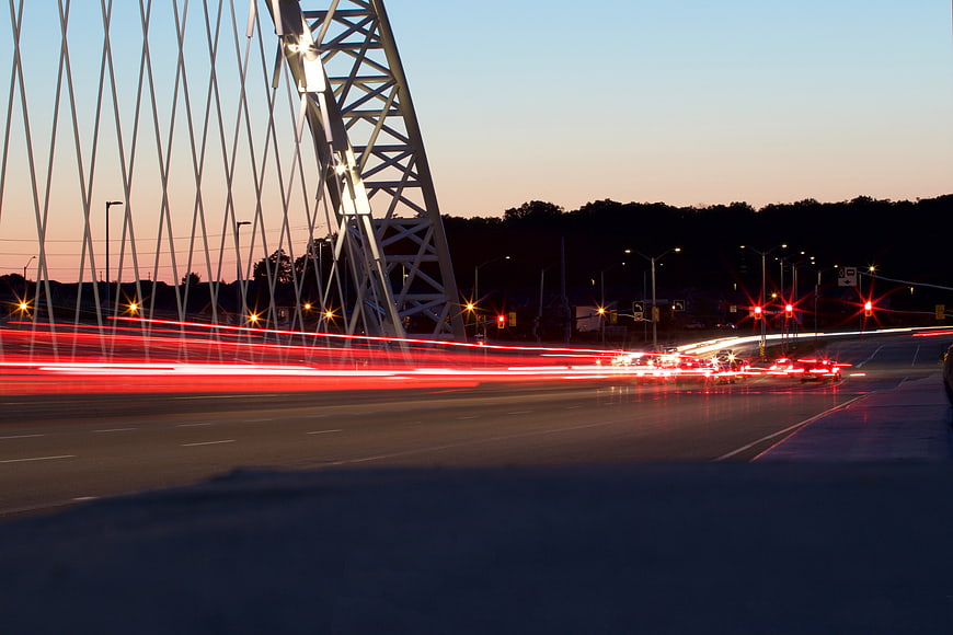 Long Exposure Traffic Light Trails on Modern Bridge at Dusk