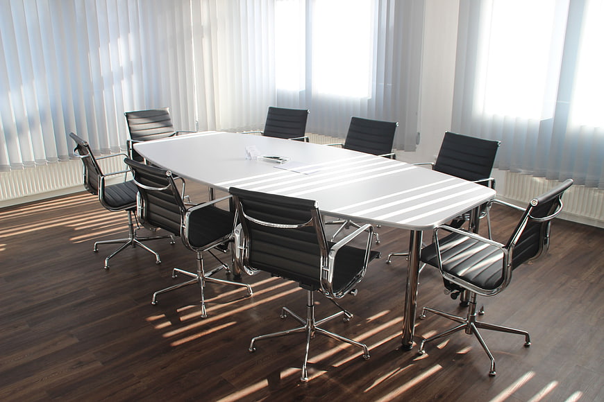 Modern Conference Room with White Table and Black Chairs