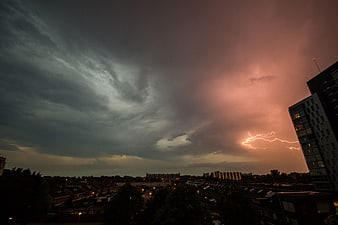 Dramatic Lightning Storm Over Urban Cityscape at Dusk