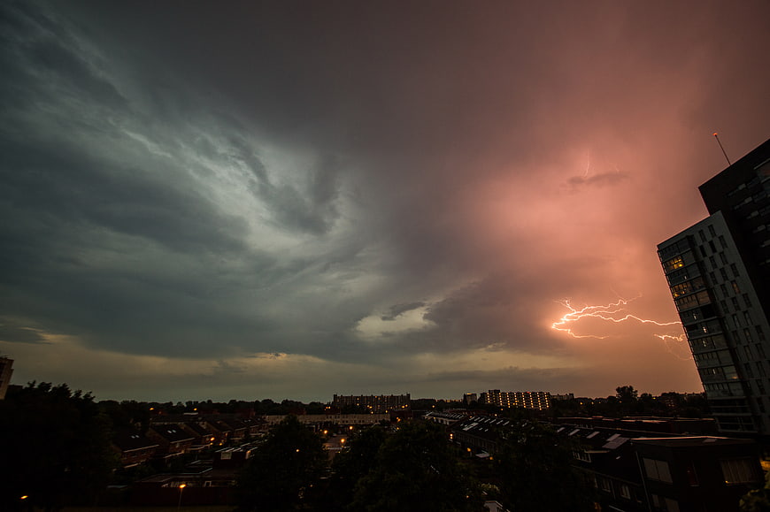 Dramatic Lightning Storm Over Urban Cityscape at Dusk