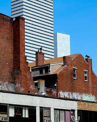 Urban Architecture Contrast: Old Brick Buildings vs Modern Skyscrapers