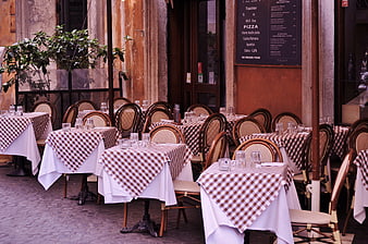 Empty outdoor tables at an Italian restaurant in Rome