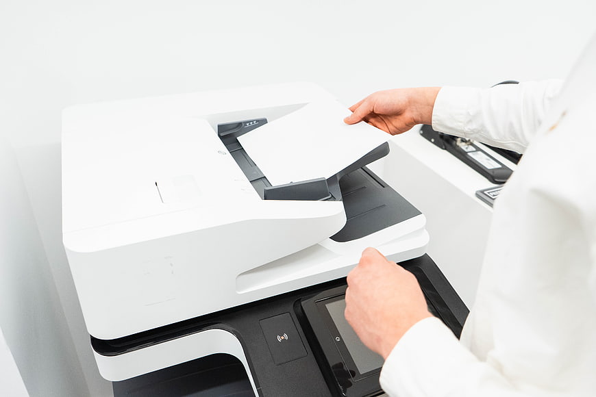 Business person using office printer and copier machine