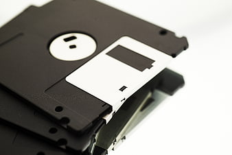 Stack of black 3.5-inch floppy disks on white background