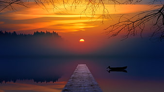 Serene Sunset Over Misty Lake with Wooden Pier and Boat