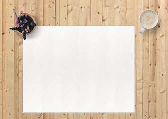 Top view of blank paper, coffee, and stationery on wooden desk