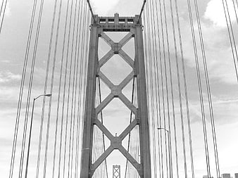 Black and white low angle view of Golden Gate Bridge tower