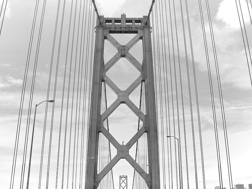 Black and white low angle view of Golden Gate Bridge tower