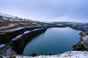 Snowy winter landscape of a flooded quarry lake