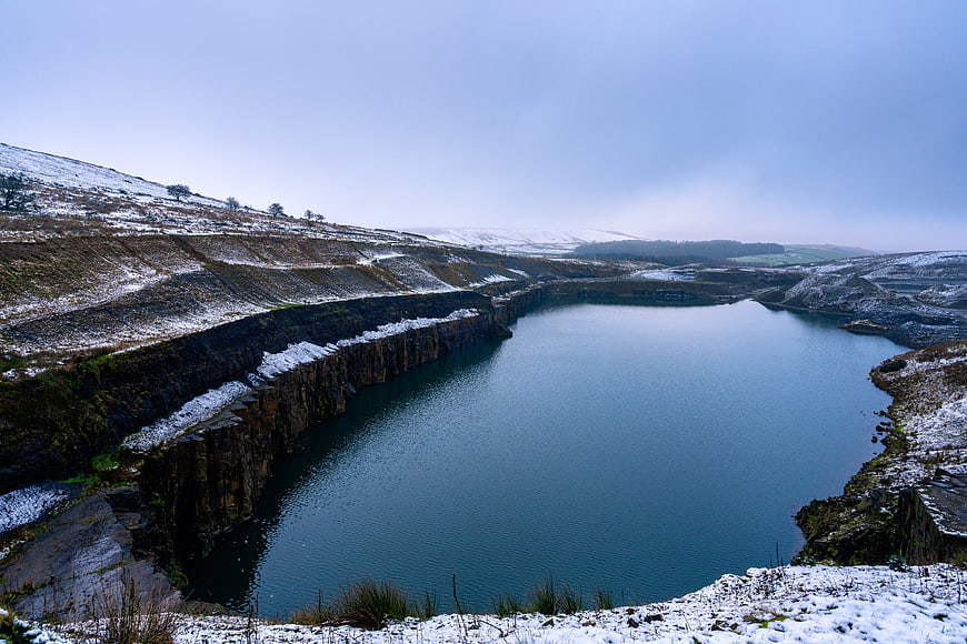Snowy winter landscape of a flooded quarry lake