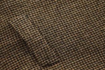 Close-up of brown and black tweed wool fabric texture