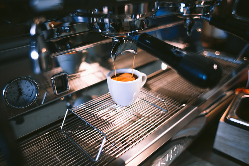 Espresso Machine Pouring Coffee into White Cup