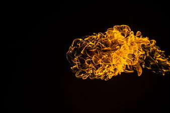 Vibrant yellow flame burst isolated on black background