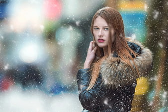 Woman in Winter Parka Standing in Snowfall