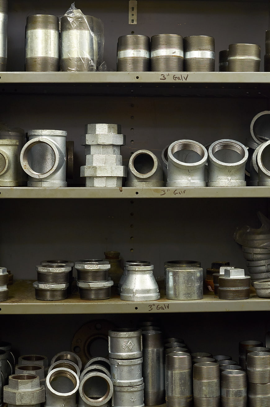 Shelves of galvanized steel pipe fittings and hardware