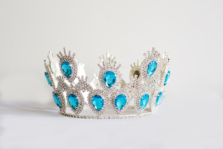 Silver Tiara with Blue Gemstones on White Background