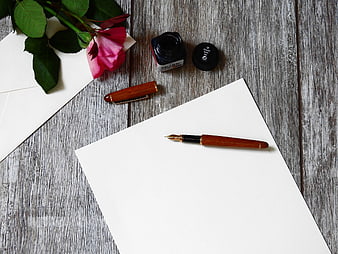 Fountain Pen, Ink, and Rose on White Paper