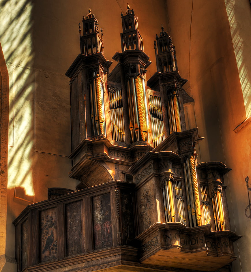 Sunlit Baroque Church Organ Pipes and Wooden Case