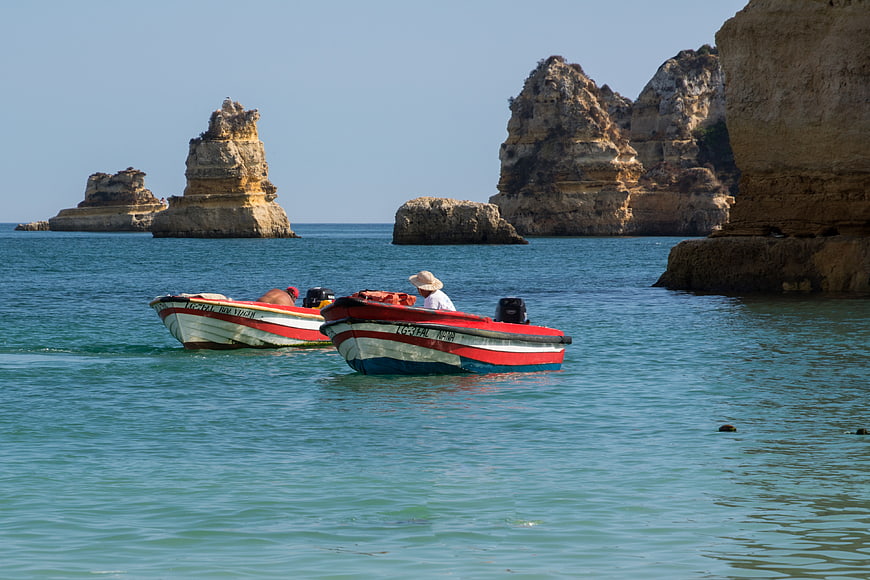 Traditional Portuguese Fishing Boats Near Coastal Cliffs