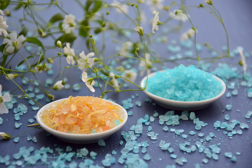 Bath Salts with Baby's Breath Flowers on Blue Background