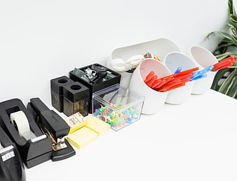 Organized office supplies on white desk with copyspace