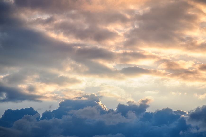 Dramatic sunset sky with golden clouds and blue shadows